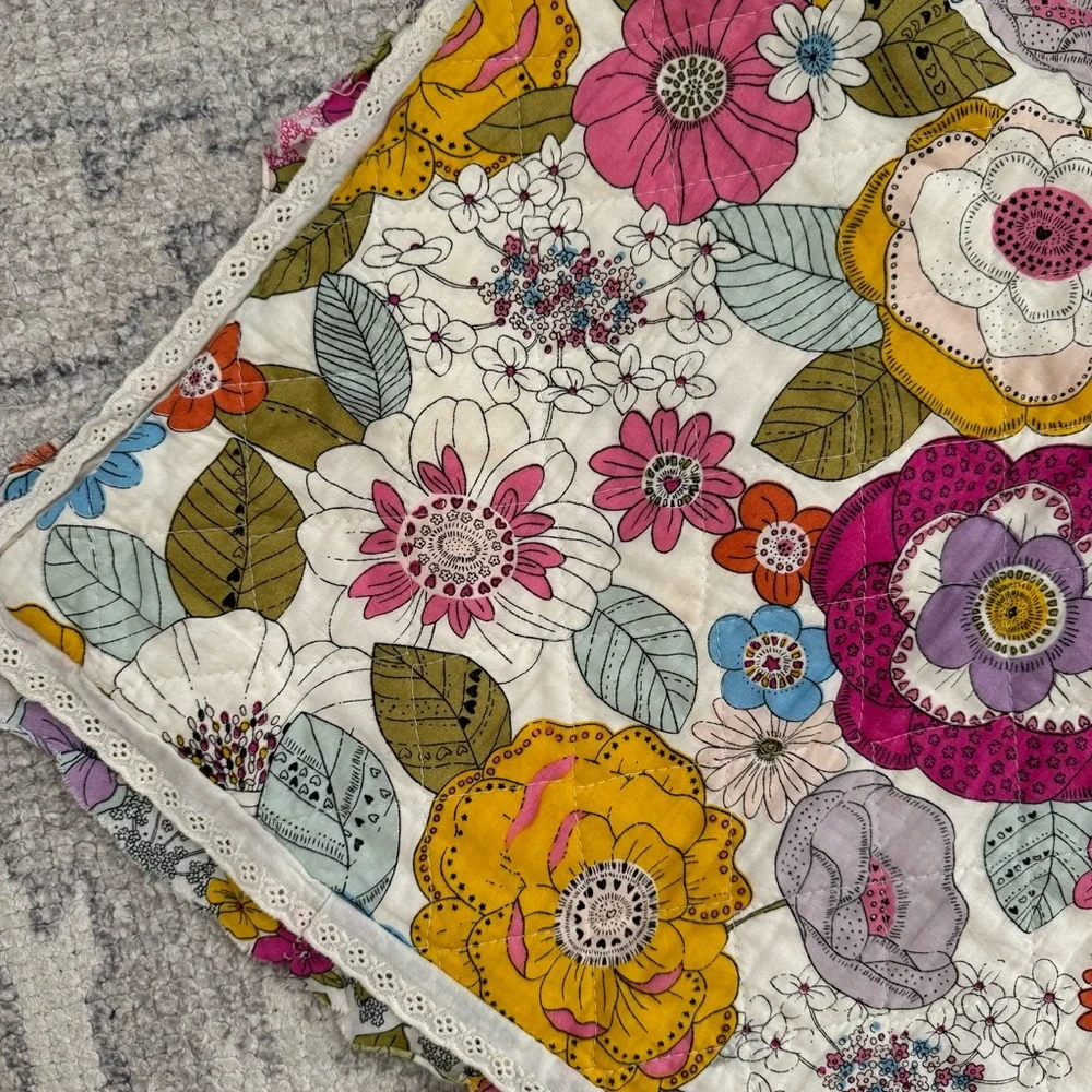 Cynthia Rowley quilted pillow sham with a multicolored boho floral pattern.